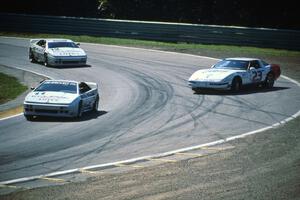 Paul Newman's and Bo Lemler's Lotus Esprit X180Rs pass Jay Sperry's sliding Chevy Corvette
