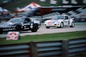 Hurley Haywood's Porsche 911 Turbo prepares to pass Tony Pio Costa's Chevy Corvette into turn 14