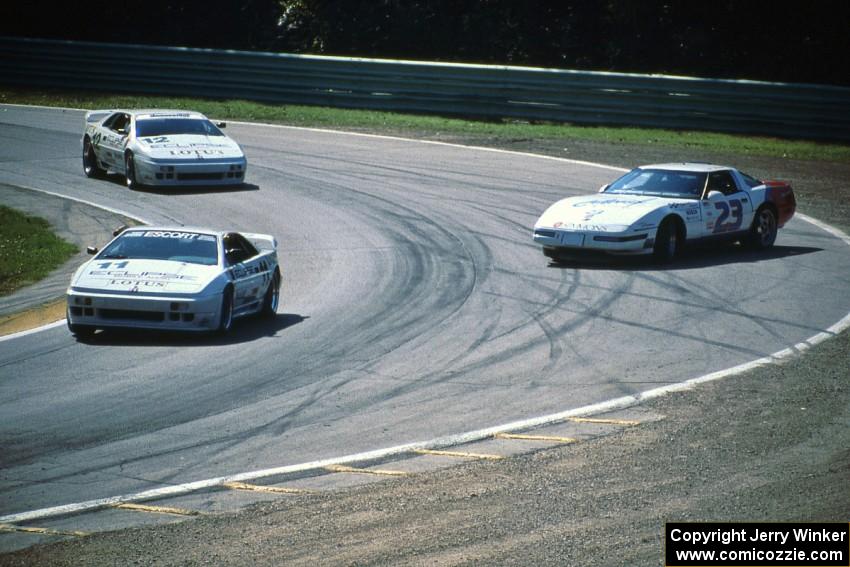 Paul Newman's and Bo Lemler's Lotus Esprit X180Rs pass Jay Sperry's sliding Chevy Corvette