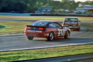 Tommy Archer's Eagle Talon chases David Daughtery's Olds Quad 442 into turn 5