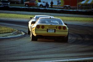 Bobby Carradine's Lotus Esprit X180R leads Shawn Hendricks' Chevy Corvette at turn 5