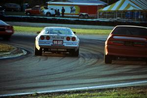John Heinricy's Chevy Corvette passes Terry Borcheller's Ford Mustang