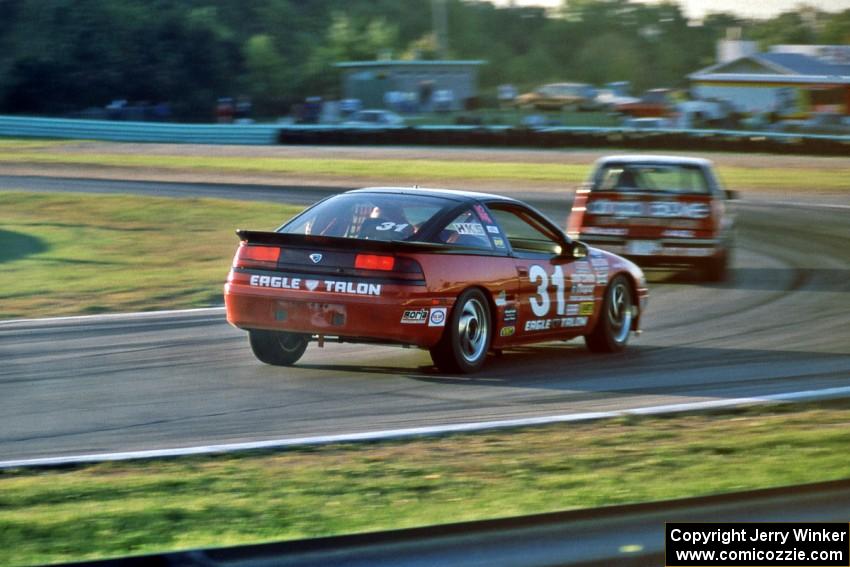 Tommy Archer's Eagle Talon chases David Daughtery's Olds Quad 442 into turn 5