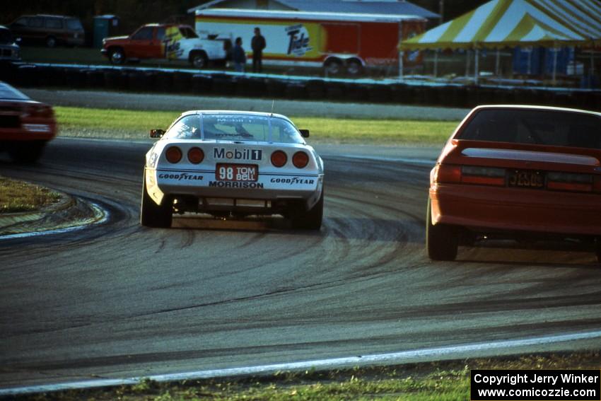 John Heinricy's Chevy Corvette passes Terry Borcheller's Ford Mustang