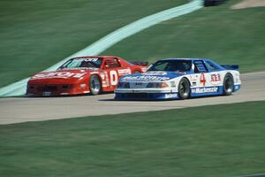 Ron Fellows' Ford Mustang passes John Anderson's Chevy Camaro headed uphill toward turn 6