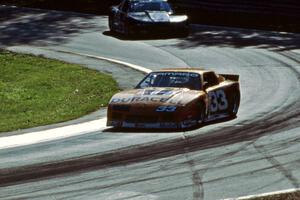 Scott Sharp's Chevy Camaro leads Darin Brassfield's Olds Cutlass Supreme