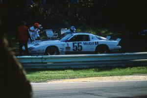 Bob Sobey's Chevy Camaro is pushed behind the guardrail at Canada Corner