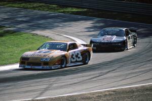 Scott Sharp's Chevy Camaro leads Darin Brassfield's Olds Cutlass Supreme