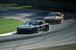 Darin Brassfield's Olds Cutlass Supreme leads Scott Sharp's Chevy Camaro