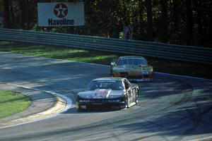 Darin Brassfield's Olds Cutlass Supreme leads Scott Sharp's Chevy Camaro