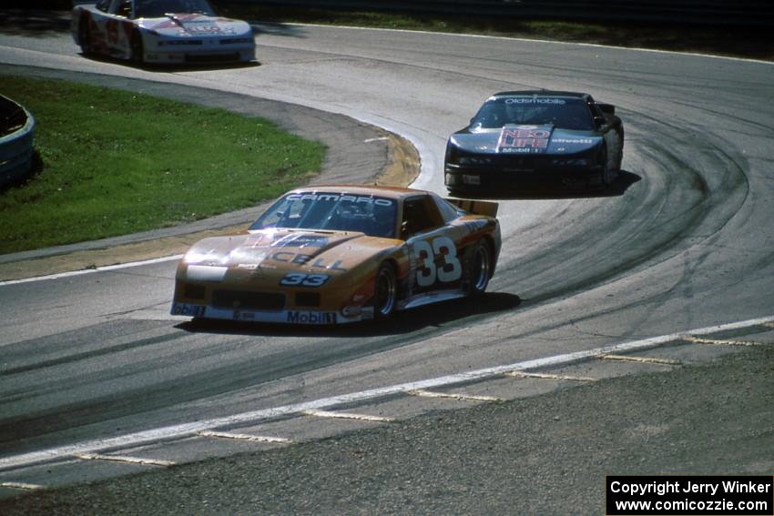 Scott Sharp's Chevy Camaro leads Darin Brassfield's and Chris Kneifel's Olds Cutlass Supremes