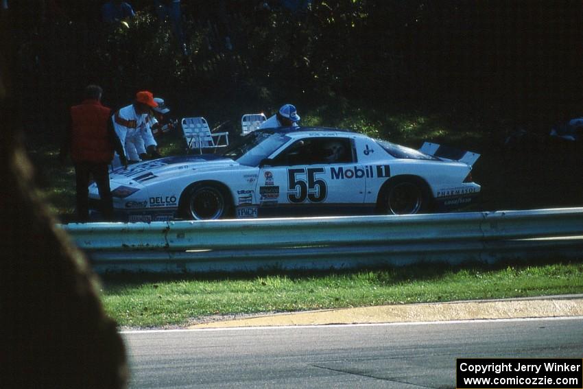 Bob Sobey's Chevy Camaro is pushed behind the guardrail at Canada Corner