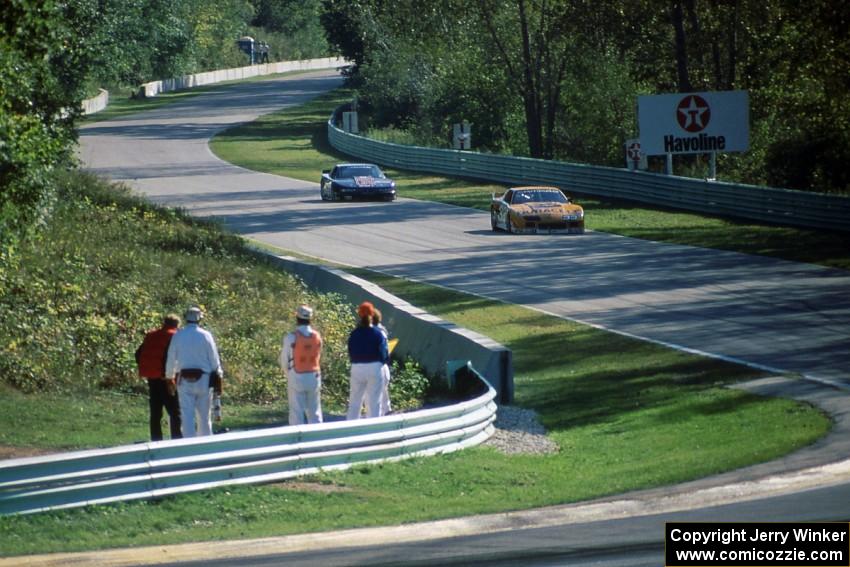 Scott Sharp's Chevy Camaro leads Darin Brassfield's Olds Cutlass Supreme into Canada Corner
