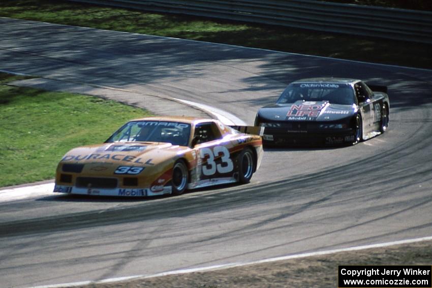 Scott Sharp's Chevy Camaro leads Darin Brassfield's Olds Cutlass Supreme