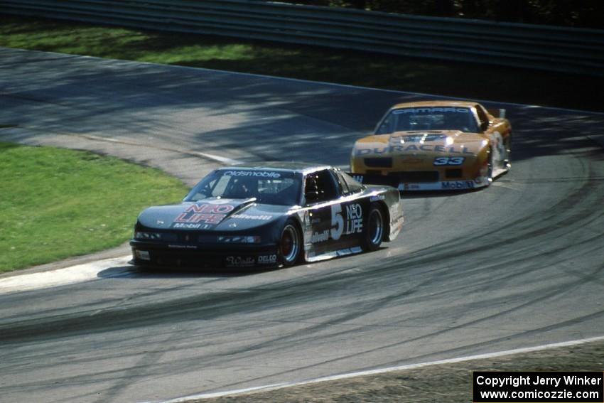 Darin Brassfield's Olds Cutlass Supreme leads Scott Sharp's Chevy Camaro