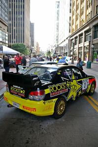 The Andy Pinker / Robbie Durant Subaru WRX STi parked directly under a skyway in front of the IDS Tower (2).