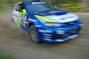 Travis Pastrana / Derek Ringer at a 90-right on SS2 in their Subaru WRX STi.