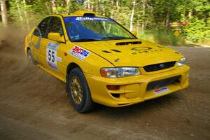 Kyle Sarasin / Mikael Johansson drift their Subaru Impreza through a right-hander on SS2.