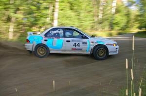 Henry Krolikowski / Cindy Krolikowski drift through a 90-right on SS2 in their Subaru Impreza.