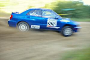 The George Georgakopoulos / Faruq Mays Subaru WRX at speed through a fast right-hander on SS2.