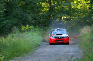 Andy Pinker / Robbie Durant at speed down a short straight on SS3 in their Subaru WRX STi.