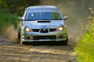 Piotr Wiktorczyk / Chrissie Beavis set up for a left-hand sweeper on SS3 in their Subaru WRX STi.