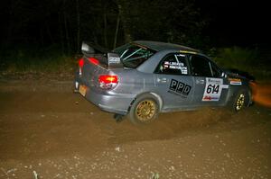 Piotr Wiktorczyk / Chrissie Beavis fly through a fast left-hander on SS5 in their Subaru WRX STi.