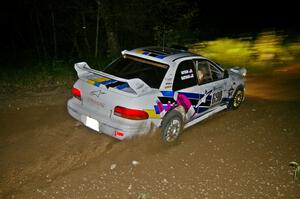 Kenny Bartram / Dennis Hotson drift through a fast downhill left-hander on SS5 in their Subaru Impreza.