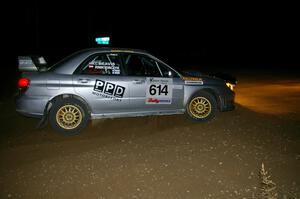 Piotr Wiktorczyk / Chrissie Beavis exit a right-hand hairpin on SS8 in their Subaru WRX STi.