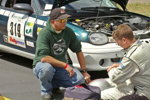 Chris Greenhouse (on the right) confers with a crew member for his Plymouth Neon. Don DeRose was his co-driver for the event.