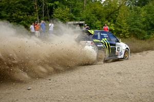 Ken Block / Alex Gelsomino sling gravel through a fast corner on SS10 in their Subaru WRX STi.