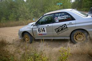 Piotr Wiktorczyk / Chrissie Beavis hug close to the apex of a fast left-hander on SS10 in their Subaru WRX STi.