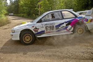 The Subaru Impreza of Kenny Bartram / Dennis Hotson drifts wide at a fast left-hander on SS10.