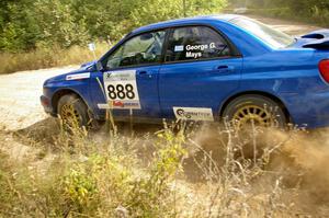 The George Georgakopoulos / Faruq Mays Subaru WRX at speed through a fast left-sweeper on SS10.