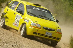 The Jim Stevens / Marianne Stevens Suzuki Swift drifts through a sweeper on SS10.