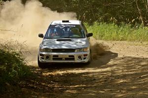 The Bob Olson / Conrad Ketelsen Subaru Impreza 2.5 RS blasts through an uphill 90-right on SS12.