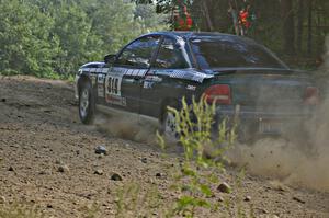 Chris Greenhouse / Don DeRose through an uphill right-hander on SS12 in their Plymouth Neon.