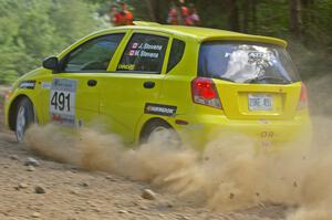 The Suzuki Swift of Jim Stevens / Marianne Stevens heads into an uphill right on SS12.