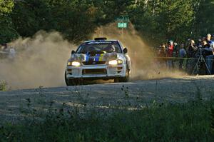 The Kenny Bartram / Dennis Hotson Subaru Impreza slings gravel at the spectator location on SS13.