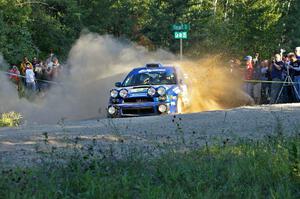 Heath Nunnemacher / Kim DeMotte spray gravel at the spectator point on SS13 in their Subaru WRX.