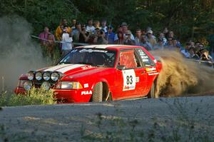 Mark Utecht / Rob Bohn spray gravel as they drive past spectators on SS13 in their Ford Mustang.