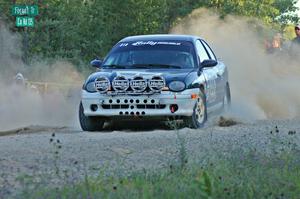 Chris Greenhouse / Don DeRose sling gravel as they enter onto the county road spectator point on SS13 in their Plymouth Neon.