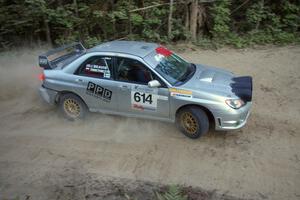 Piotr Wiktorczyk / Chrissie Beavis drift wide through a corner on SS15 in their Subaru WRX STi.