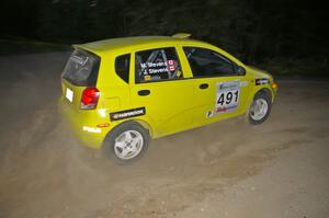 Jim Stevens / Marianne Stevens at speed through a 90-right on SS15 in their Suzuki Swift.