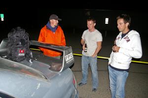Piotr Wiktorczyk and crew take a breather behind their Subaru WRX STi at the end of the event.