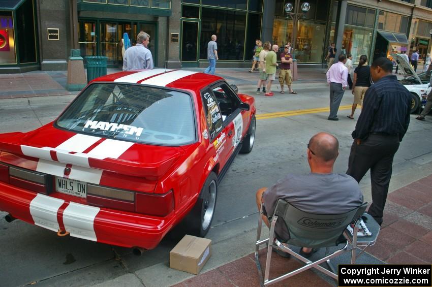 Mark Utecht relaxes next to the Ford Mustang he and Rob Bohn shared (1).