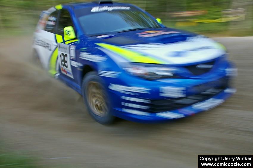 Travis Pastrana / Derek Ringer at a 90-right on SS2 in their Subaru WRX STi.