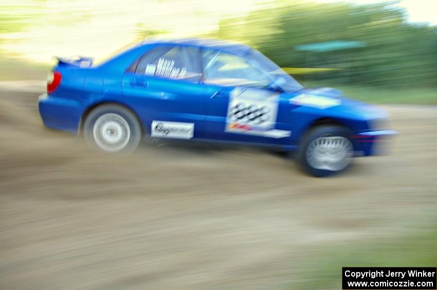 The George Georgakopoulos / Faruq Mays Subaru WRX at speed through a fast right-hander on SS2.