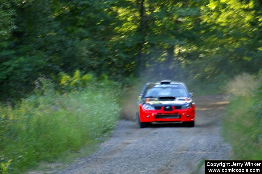 Andy Pinker / Robbie Durant at speed down a short straight on SS3 in their Subaru WRX STi.