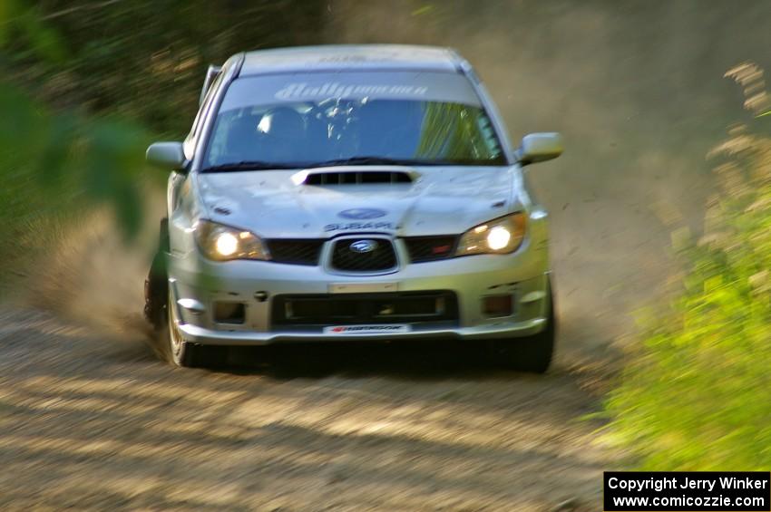 Piotr Wiktorczyk / Chrissie Beavis set up for a left-hand sweeper on SS3 in their Subaru WRX STi.